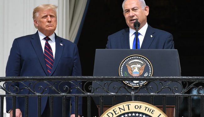 US President Donald Trump watches as Israeli Prime Minister Benjamin Netanyahu (R) speaks from the Truman Balcony at the White House during the signing ceremony of the Abraham Accords where the countries of Bahrain and the United Arab Emirates recognize Israel, on the South Lawn of the White House in Washington, DC, September 15, 2020. - Israeli Prime Minister Benjamin Netanyahu and the foreign ministers of Bahrain and the United Arab Emirates arrived September 15, 2020 at the White House to sign historic accords normalizing ties between the Jewish and Arab states. (Photo by SAUL LOEB / AFP)