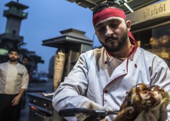 Syrian refugee Adel Bazmawi, 21, a co-founder and coach of the Syrian Sports Academy, works at a restaurant in Egypt's second city of Alexandria on January 4, 2018.
The academy is squeezed into just 30 square metres (320 square feet), in a modestly equipped hall at the bottom of a residential building in the Alexandria neighbourhood. The academy's founders began the project in 2016 with just 3,000 Egyptian pounds (about $430 at the time).
 / AFP PHOTO / KHALED DESOUKI        (Photo credit should read KHALED DESOUKI/AFP via Getty Images)