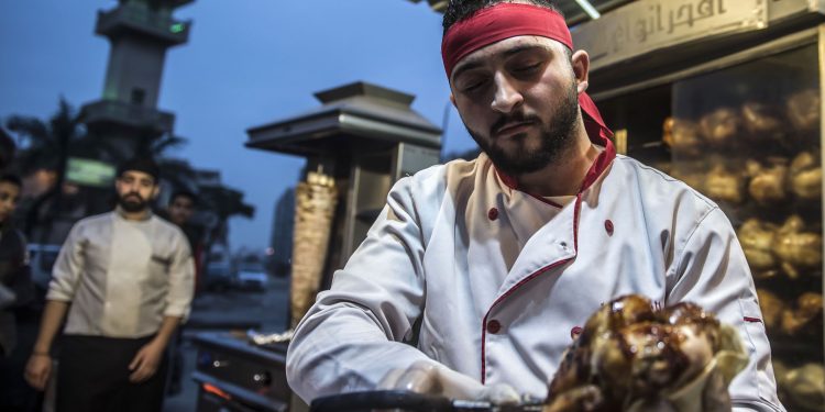 Syrian refugee Adel Bazmawi, 21, a co-founder and coach of the Syrian Sports Academy, works at a restaurant in Egypt's second city of Alexandria on January 4, 2018.
The academy is squeezed into just 30 square metres (320 square feet), in a modestly equipped hall at the bottom of a residential building in the Alexandria neighbourhood. The academy's founders began the project in 2016 with just 3,000 Egyptian pounds (about $430 at the time).
 / AFP PHOTO / KHALED DESOUKI        (Photo credit should read KHALED DESOUKI/AFP via Getty Images)