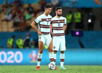 SEVILLE, SPAIN - JUNE 27: Cristiano Ronaldo and Bruno Fernandes of Portugal prepare to take a free kick during the UEFA Euro 2020 Championship Round of 16 match between Belgium and Portugal at Estadio La Cartuja on June 27, 2021 in Seville, Spain. (Photo by Fran Santiago - UEFA/UEFA via Getty Images)