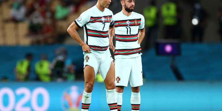 SEVILLE, SPAIN - JUNE 27: Cristiano Ronaldo and Bruno Fernandes of Portugal prepare to take a free kick during the UEFA Euro 2020 Championship Round of 16 match between Belgium and Portugal at Estadio La Cartuja on June 27, 2021 in Seville, Spain. (Photo by Fran Santiago - UEFA/UEFA via Getty Images)